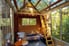 A treehouse with transparent walls and ceiling