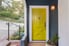 Yellow house door with white trim