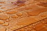 Water drops beading on wood decking.