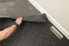 person lifting up rubber flooring