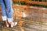 A wood deck with a pressure washer. 