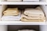 A neatly stacked linen closet.
