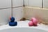 Moldy tiles and rubber duckies on a bathtub edge