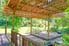 wood deck with trellis roof and growing plants