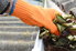 Gloved hand cleaning out a gutter