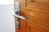Wooden door with silver lever door handle