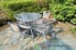 A glass patio table with matching metal-frame chairs.