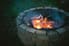 Metal fire pit surrounded by bricks