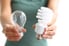 person holding two types of light bulbs
