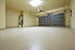 An empty garage with a painted concrete floor.