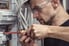 man screwing wire into circuit breaker
