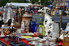 A flea market with a table full of goods for sale.