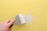 spackling a hole in a yellow wall