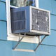 Air condition in the window of a blue house.