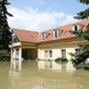 house with flooding waters surrounding it
