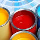 various colorful paint cans and paint chips