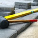 rubber mallet and level laying on paver stones