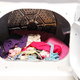 An open dryer with clothes inside.