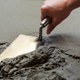 A person smoothing concrete.