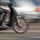 a black moped in motion