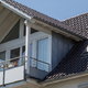 metal gable roof with second floor balcony