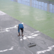 man applying epoxy to a large floor