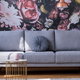 floral wall with gray sofa and wicker table