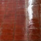 Reddish vinyl flooring with a bright shine.