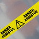 Caution tape warning of asbestos danger.