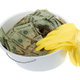 A white bucket with yellow gloves and cash. 