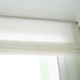 white Roman blinds on a window