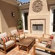 patio with furniture and brick fireplace