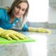 woman cleaning a stone countertop
