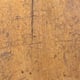 A scratched old wooden table surface.