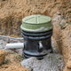 An unburied grinder pump holding tank.