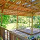 wood deck with trellis roof and growing plants