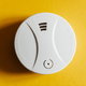 carbon monoxide detector on yellow wall