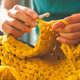 hands knitting golden fabric