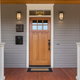 entranceway door with wood frame on porch