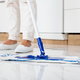 A mop cleaning a kitchen floor. 