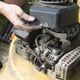 hands repairing lawn mower engine