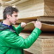 A man looks at birch plywood.