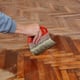 A man applying finish to a wood floor.