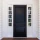 a black door surrounded by windows