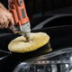 hands buffing car with drill buffer