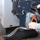 hands repairing an oil furnace heating system