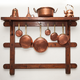 copper pots and pans on a rack