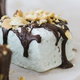 delicious looking homemade marshmallows dipped in chocolate with crumbled nuts