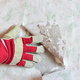 gloved hand peeling back wallpaper