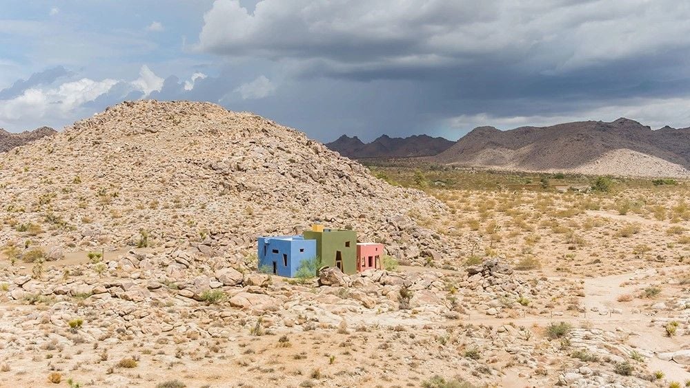 Josh Schweitzer's multi-colored Monument House in the context of its desert setting.